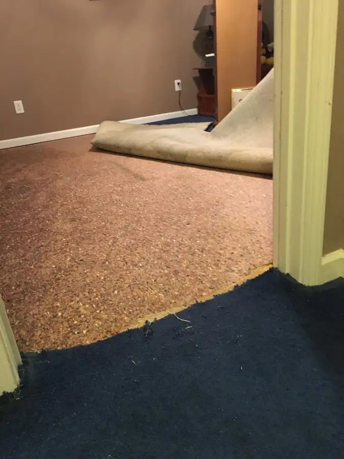 Carpet pad removal revealing water damage during Water Mitigation Services in Eastern Goleta Valley